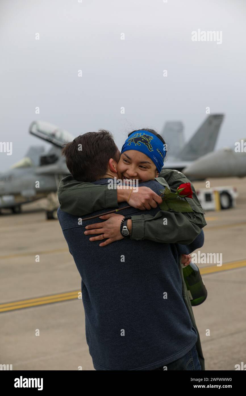 240115-N-YM590-1103 VIRGINIA BEACH, Va. (Jan. 15, 2024)- A pilot, assigned to the “Fighting Blacklions” of Strike Fighter Squadron (VFA) 213, reunites with her family after returning to Naval Air Station Oceana in Virginia, Jan. 15, following a more than eight-month deployment with the Gerald R. Ford Carrier Strike Group. While deployed, the squadron accomplished 1,943 sorties covering 3,137 flight hours with a 97% sortie completion rate. Stock Photo