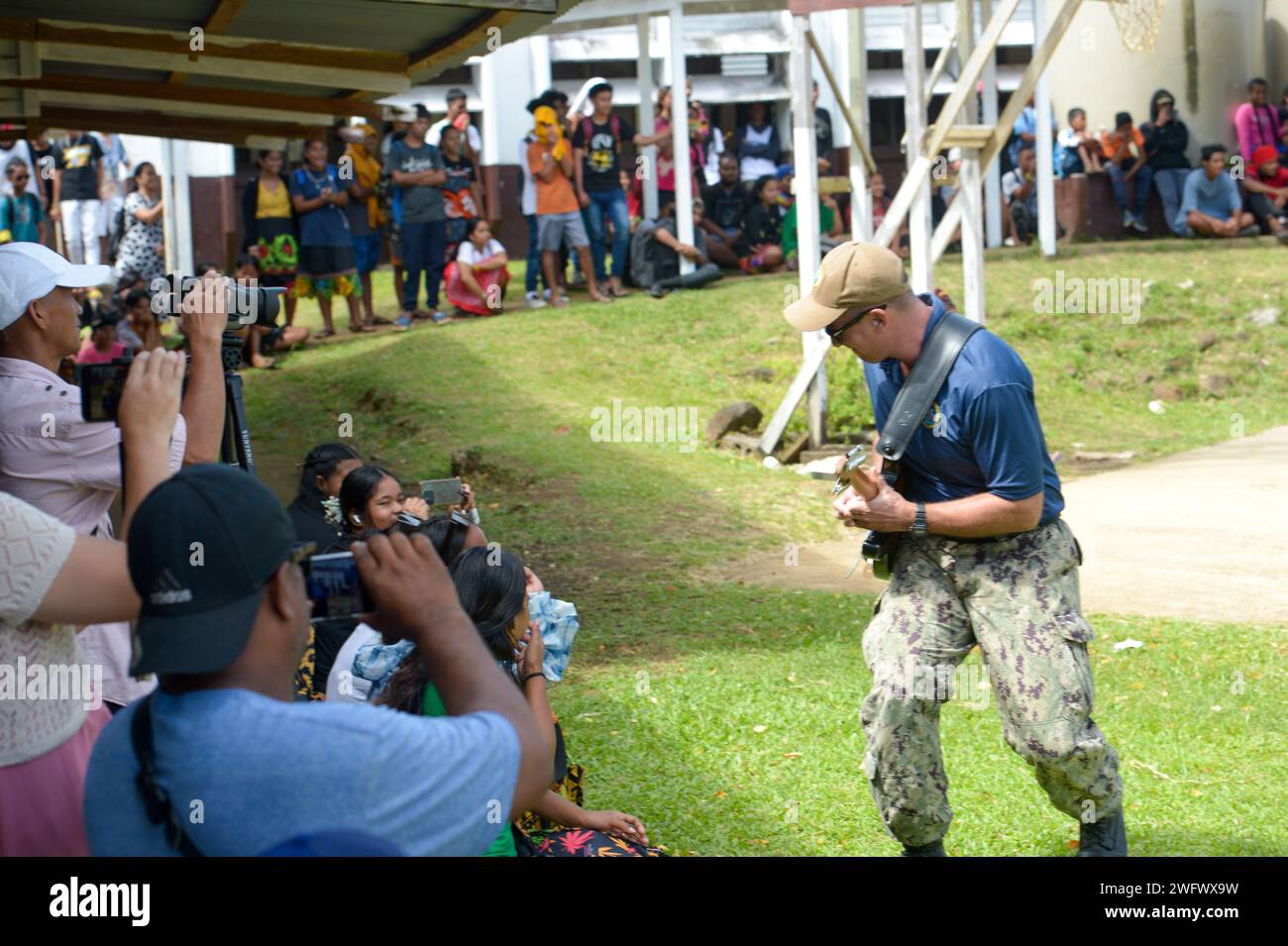 U.S. Navy Musician 3rd Class Daniel Caton, plays guitar with the Pacific Partnership Band, comprised of members from the U.S. Pacific Fleet Band and Royal Australian Navy Band, at Chuuk High School during a host nation outreach event in Chuuk, Federated States of Micronesia, as part of Pacific Partnership 2024-1, Jan. 15, 2024. Pacific Partnership, now in its 19th iteration, is the largest multinational humanitarian assistance and disaster relief preparedness mission conducted in the Indo-Pacific and works to enhance regional interoperability and disaster response capabilities, increase securi Stock Photo