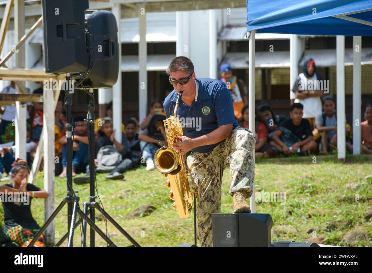 U.S. Navy Musician 2nd Class Owen Sczerba, from Poughkeepsie, New York, plays saxophone with the Pacific Partnership Band, comprised of members from the U.S. Pacific Fleet Band and Royal Australian Navy Band, at Chuuk High School during a host nation outreach event in Chuuk, Federated States of Micronesia, as part of Pacific Partnership 2024-1 Jan. 15, 2024. Pacific Partnership, now in its 19th iteration, is the largest multinational humanitarian assistance and disaster relief preparedness mission conducted in the Indo-Pacific and works to enhance regional interoperability and disaster respons Stock Photo