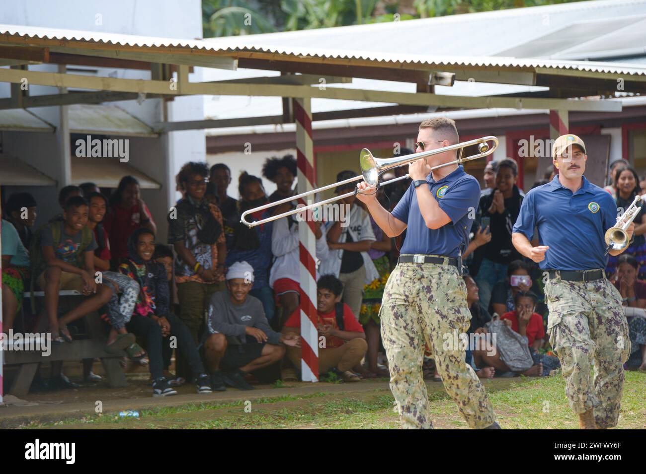 U.S. Navy Musician 3rd Class Aaron Wright, from Traverse City, Michigan, plays the trombone with the Pacific Partnership Band, comprised of members from the U.S. Pacific Fleet Band and Royal Australian Navy Band, at Chuuk High School during a host nation outreach event in Chuuk, Federated States of Micronesia, as part of Pacific Partnership 2024-1 Jan. 15, 2024. Pacific Partnership, now in its 19th iteration, is the largest multinational humanitarian assistance and disaster relief preparedness mission conducted in the Indo-Pacific and works to enhance regional interoperability and disaster res Stock Photo