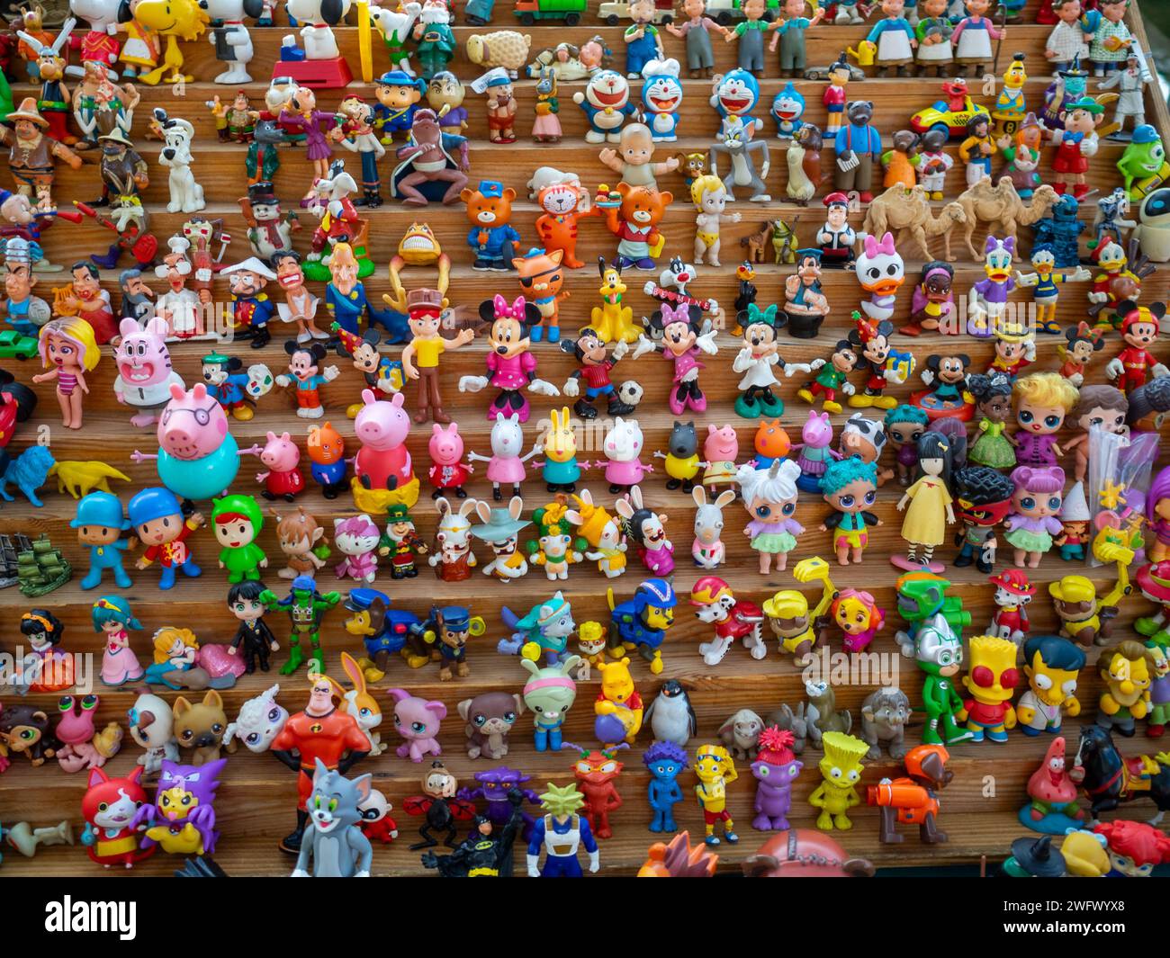 Colorful small toys lined up in street market stall Stock Photo