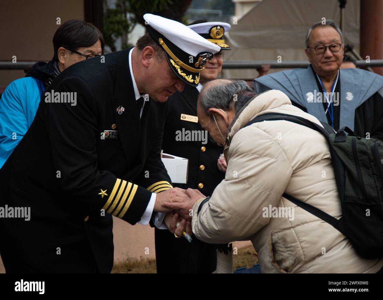 Capt. Michael Fontaine, Commander, Fleet Activities Sasebo, hands out ...