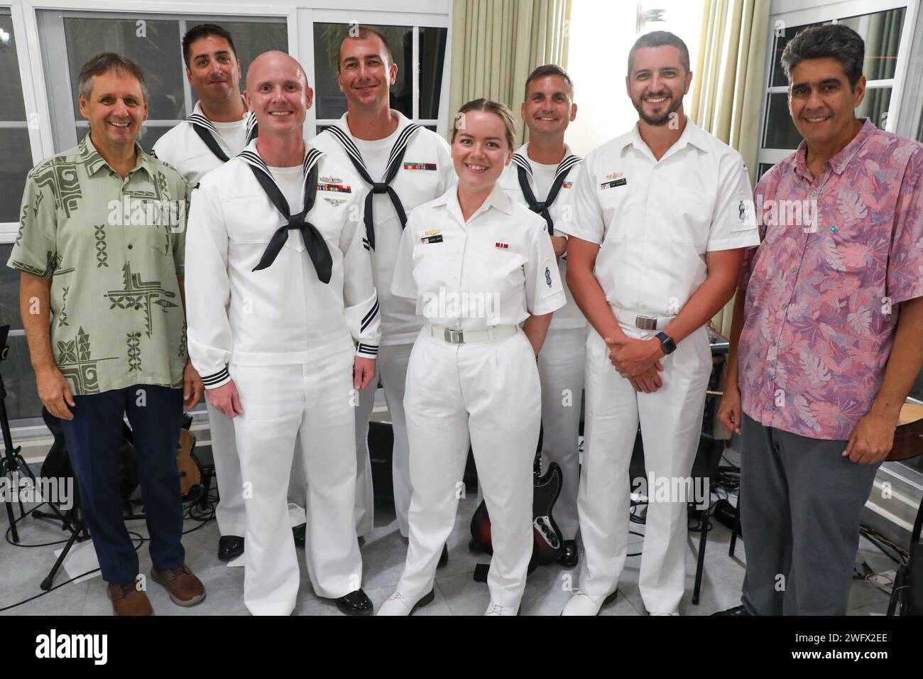 The Pacific Partnership Band, consisting of U.S. Navy and Australian sailors, pose for a photo with U.S. Ambassador to Palau Joel Ehrendreich, left, and President Surangel Whipps Jr., the president of Palau, right, during the mission stop closing ceremonies in Koror, Palau, as part of Pacific Partnership 2024-1 Jan. 4, 2024. Now in its 19th iteration, Pacific Partnership is the largest annual multinational humanitarian assistance and disaster relief preparedness mission conducted in the Indo-Pacific. Stock Photo