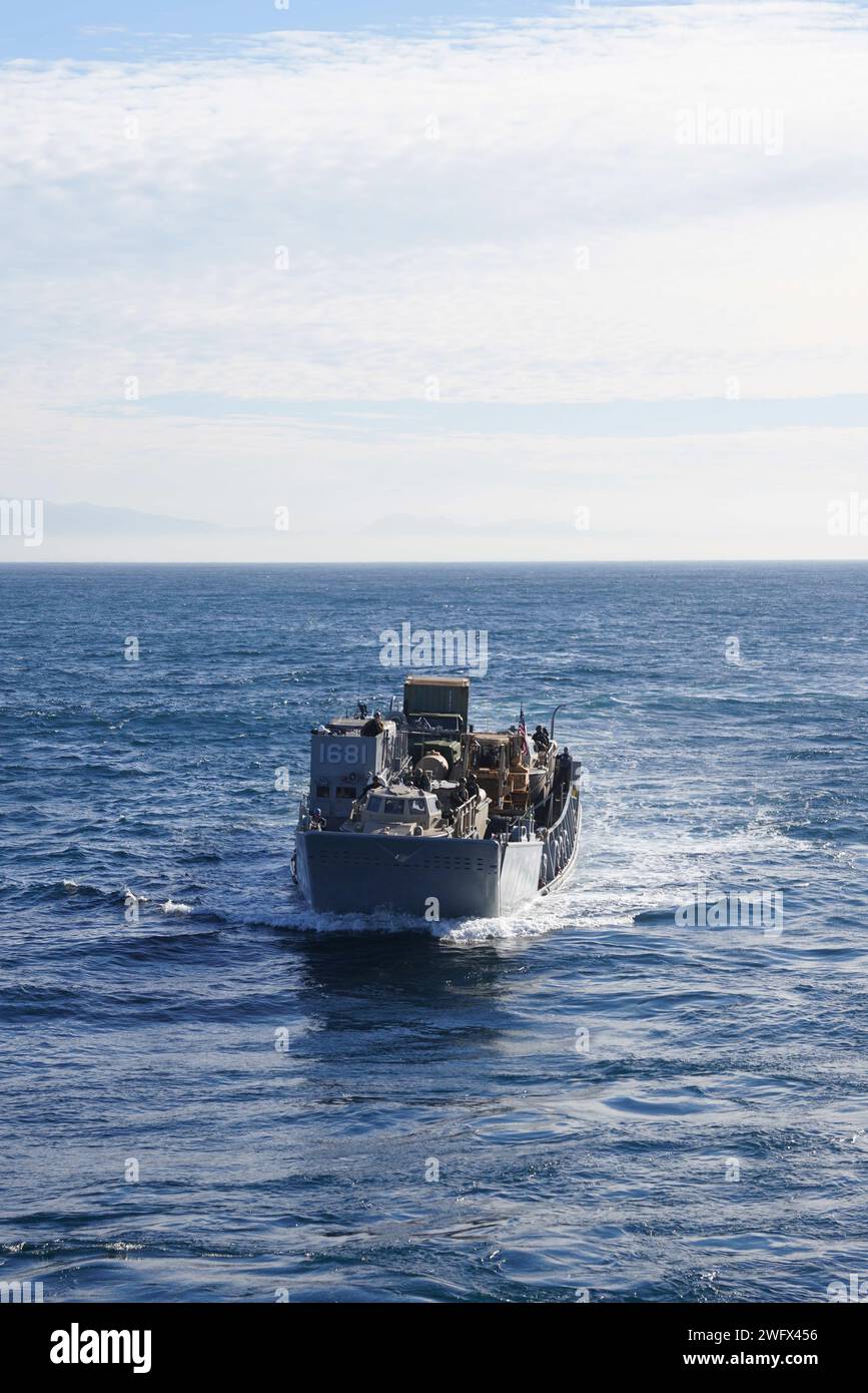 U.S. Navy Landing Craft, Utility (LCU) 1681, assigned to Assault Craft Unit (ACU) 1, transits toward amphibious dock landing ship USS Harpers Ferry (LSD 4), in the Pacific Ocean, Jan. 5, 2024. The Boxer Amphibious Ready Group, comprised of USS Boxer (LHD 4), USS Somerset (LPD 25), and Harpers Ferry, and the embarked 15th Marine Expeditionary Unit are underway conducting integrated training and routine operations in U.S. 3rd Fleet. Stock Photo
