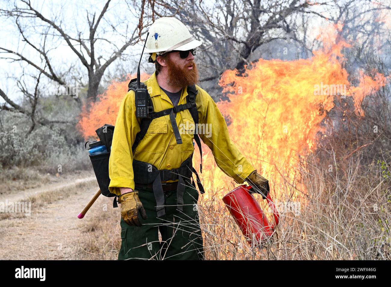 A firefighter with the U.S. Air Force Wildland Fire Branch, uses a drip
