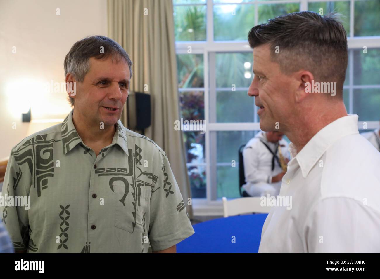 Ambassador Joel Ehrendreich, the U.S. Ambassador to Palau, left, and U.S. Navy Capt. Jeffrey Feinberg, the commanding officer of the hospital ship USNS Mercy (T-AH 19), speak during the mission stop closing ceremonies in Koror, Palau, as part of Pacific Partnership 2024-1 Jan. 4, 2024. Now in its 19th iteration, Pacific Partnership is the largest annual multinational humanitarian assistance and disaster relief preparedness mission conducted in the Indo-Pacific. Stock Photo
