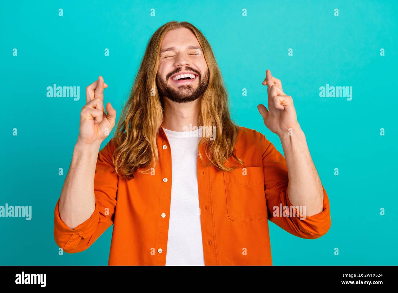 Portrait photo of young jesus christ handsome guy in orange shirt
