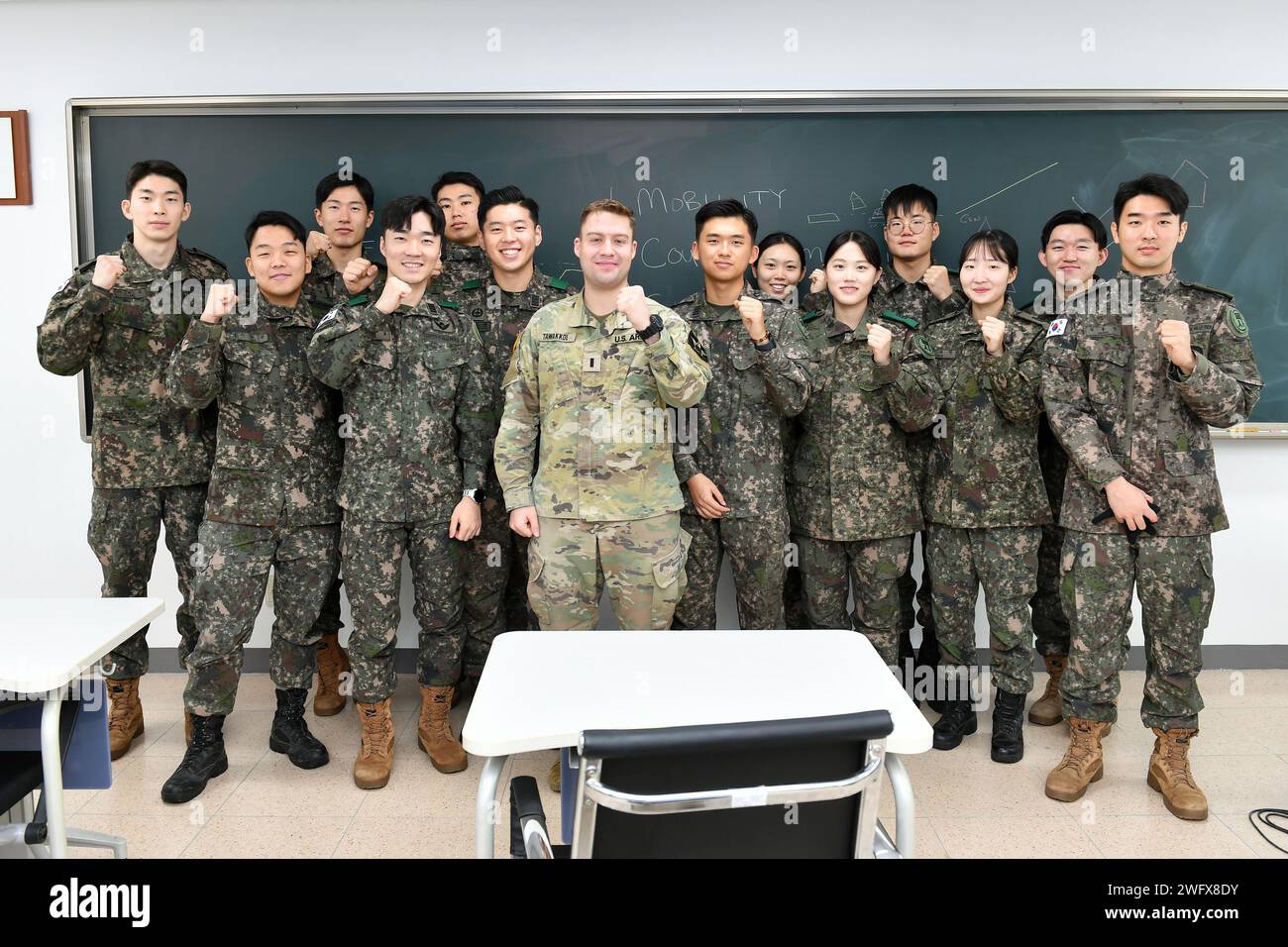 1st Lt. Adam Tawakkol, an engineering officer with 643rd Engineer Construction Company, 11th Engineer Battalion, 2nd Division Sustainment Brigade, 2nd Infantry Division/ROK U.S. Combined Division, poses with cadets from the Korean Military Academy in Seoul, South Korea, Jan. 12, 2024. The KMA and 2ID/RUCD have been expanding their cooperative relationship since signing a memorandum of understanding in 2016; and this interaction between cadets and U.S. officers is just one part of that expansion. Stock Photo
