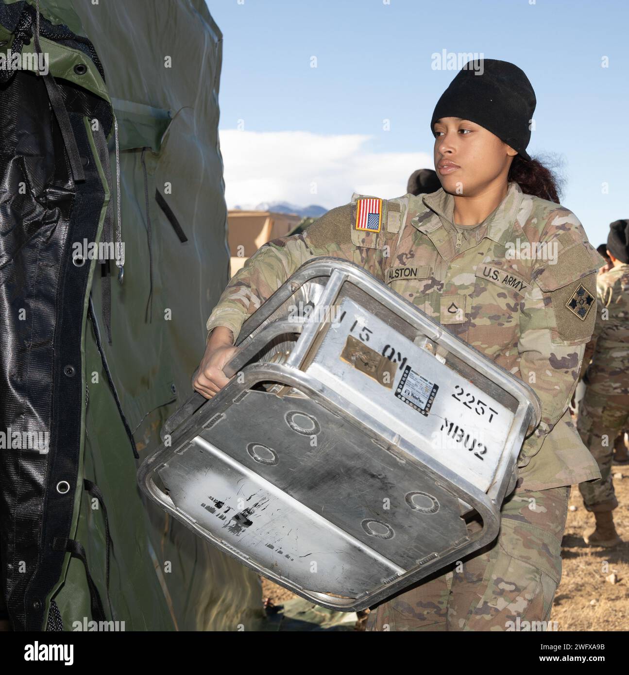 Culinary Specialist, Pfc. Bryanna Alston, assigned to the 115th Quartermaster Field Feeding Company, 4th Division Sustainment Brigade, carries sanitation equipment during the Connelly Competition, Jan. 17, 2024, on Fort Carson, Colo. The Connelly Competition grades Soldiers on not just culinary ability but full feeding operations in a field environment. Stock Photo