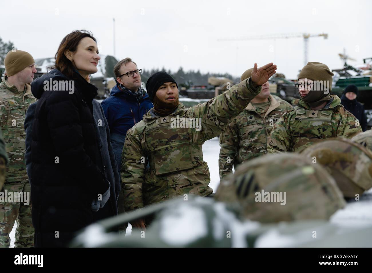 U.S. Army Staff Sgt. Vincent Espinar, a tank commander with 3rd Battalion, 67th Armored Regiment, 2nd Armored Brigade Combat Team, 3rd Infantry Division, shares his knowledge of the M1A2 Abrams tank with Lithuanian Speaker of Parliament Viktorija Čmilytė-Nielsen during a tour of Camp Herkus, Lithuania, Jan. 4, 2024. The 3rd Infantry Division’s mission in Europe is to engage in multinational training and exercises across the continent, working alongside NATO Allies and regional security partners to provide combat-credible forces to V Corps, America’s forward deployed corps in Europe. Stock Photo