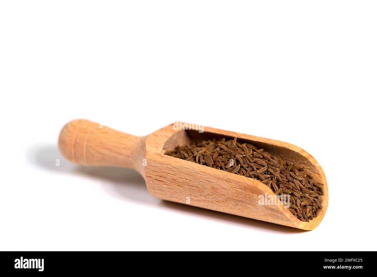 Cumin seeds on a spice scoop Stock Photo