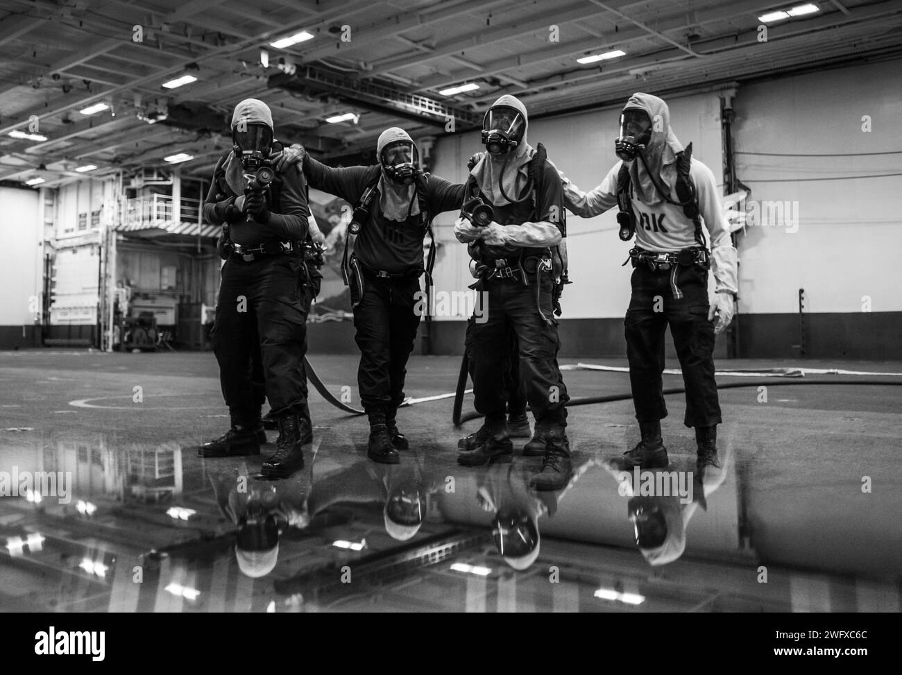 Sailors participate in an air department training team drill on Nimitz-class aircraft carrier USS George Washington (CVN 73), Jan. 16, 2024. George Washington is underway in support of carrier qualifications. Stock Photo