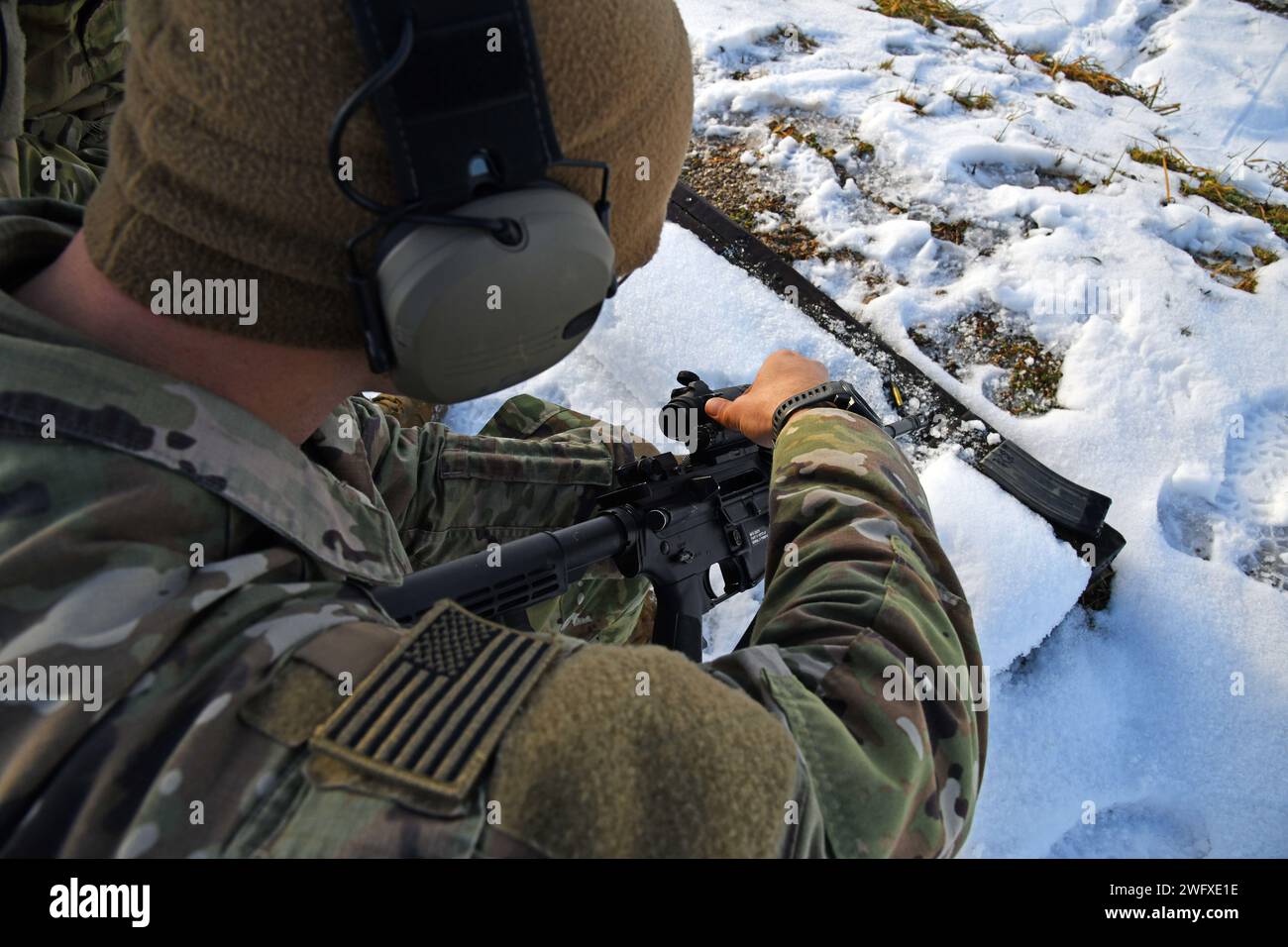 A U. S. Army paratrooper assigned to the 54th Brigade Engineer Battalion, 173rd Airborne Brigade, adjusts his weapon before M4 carbine qualifications as part of Castle Dvorac 24 in Slunj, Croatia, Jan. 23, 2024. The 173rd Airborne Brigade is the U.S. Army's Contingency Response Force in Europe, providing rapidly deployable forces to the United States European, African, and Central Command areas of responsibility. Forward deployed across Italy and Germany, the brigade routinely trains alongside NATO allies and partners to build partnerships and strengthen the alliance. Stock Photo