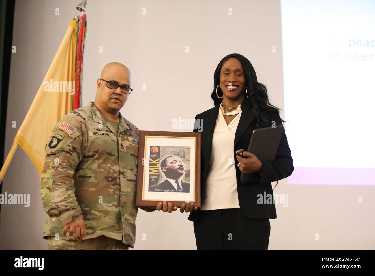 U.S. Army Capt. Chaplain Tammy Briggs receives a token of appreciation for being the guest speaker during the MLK ceremony. Stock Photo