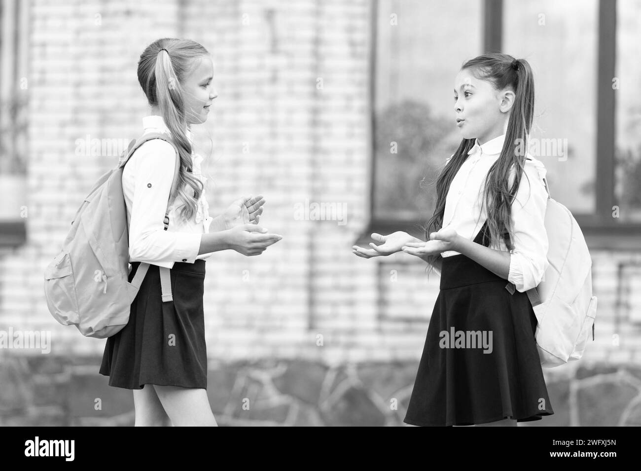 two tween girls friends talking together outdoor Stock Photo - Alamy