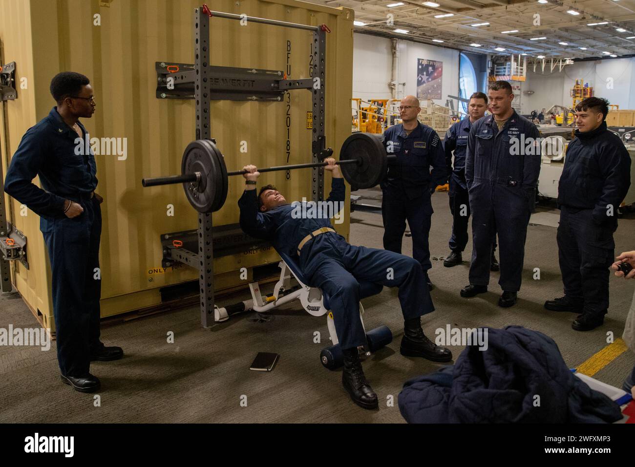 Sailors aboard Nimitz-class aircraft carrier USS George Washington (CVN 73) participate in an incline bench press challenge hosted by Morale Welfare Recreation in the Atlantic Ocean Jan. 17, 2024. George Washington is underway in support of carrier qualifications. Stock Photo