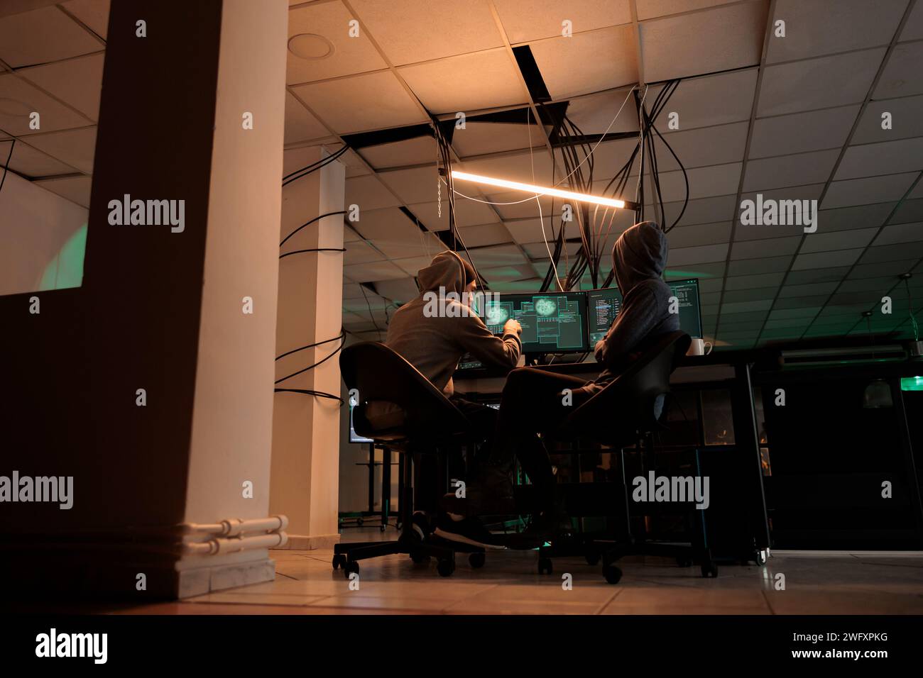 Cybercrime, hackers team coding internet virus program, hacking computer system, developers programming firewall. Criminals cracking password, developing malicious software Stock Photo