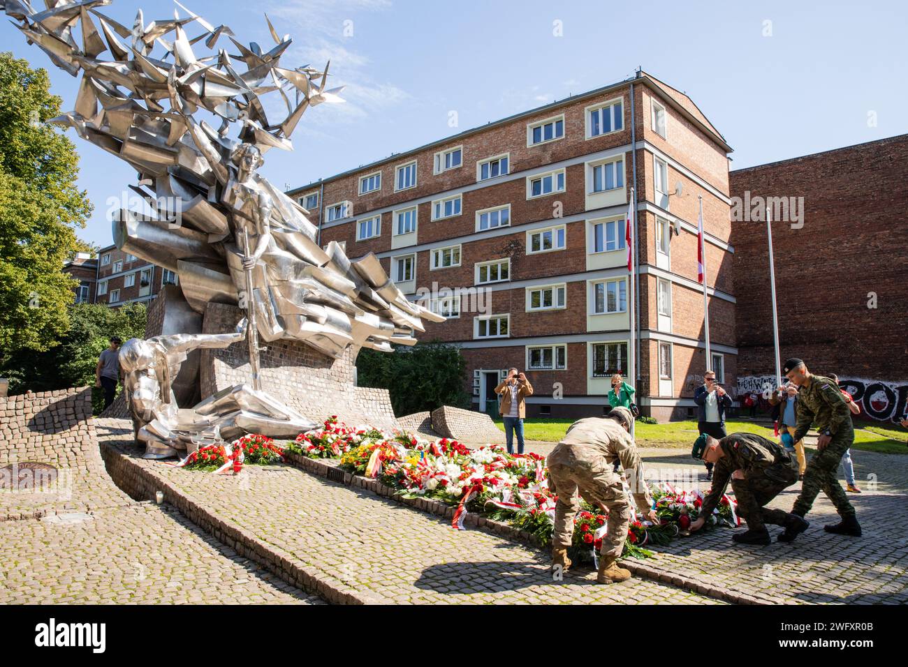 A U.S. Soldier with 1st Battalion, 9th Cavalry Regiment, 1st Cavalry Division, supporting 4th Infantry Division, a Croatian soldier with the 11th Croatian Contingent, and a Polish soldier with the 15th Mechanized Brigade, lay flower wreaths at the Monument to Defenders of the Polish Post Office Memorial in Gdansk, Poland, Sept. 2. Members of Task Force Ivy and NATO allies from the enhanced Forward Presence Battle Group Poland visited Gdansk to learn about the historical significance of the area during World War II. The 4th Inf. Div.'s mission in Europe is to engage in multinational training an Stock Photo