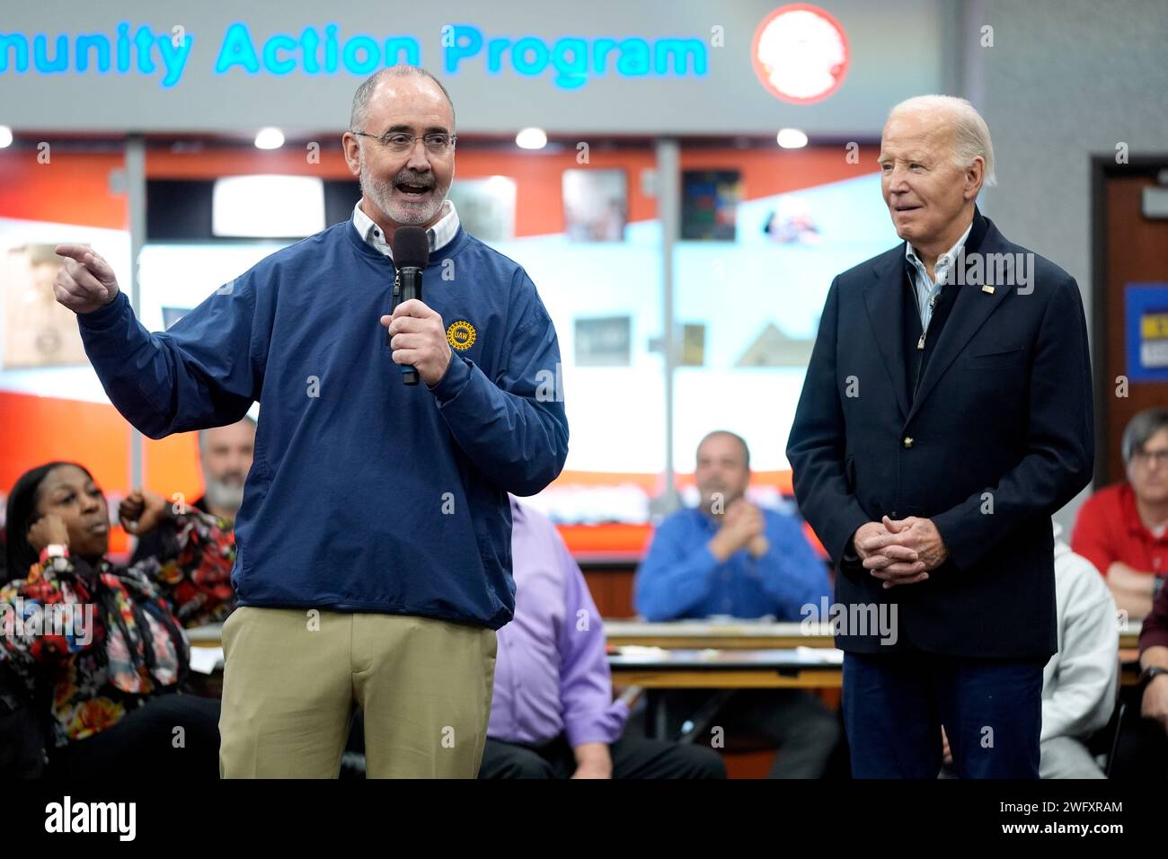 United Auto Workers President Shawn Fain, left, speaks as President Joe ...