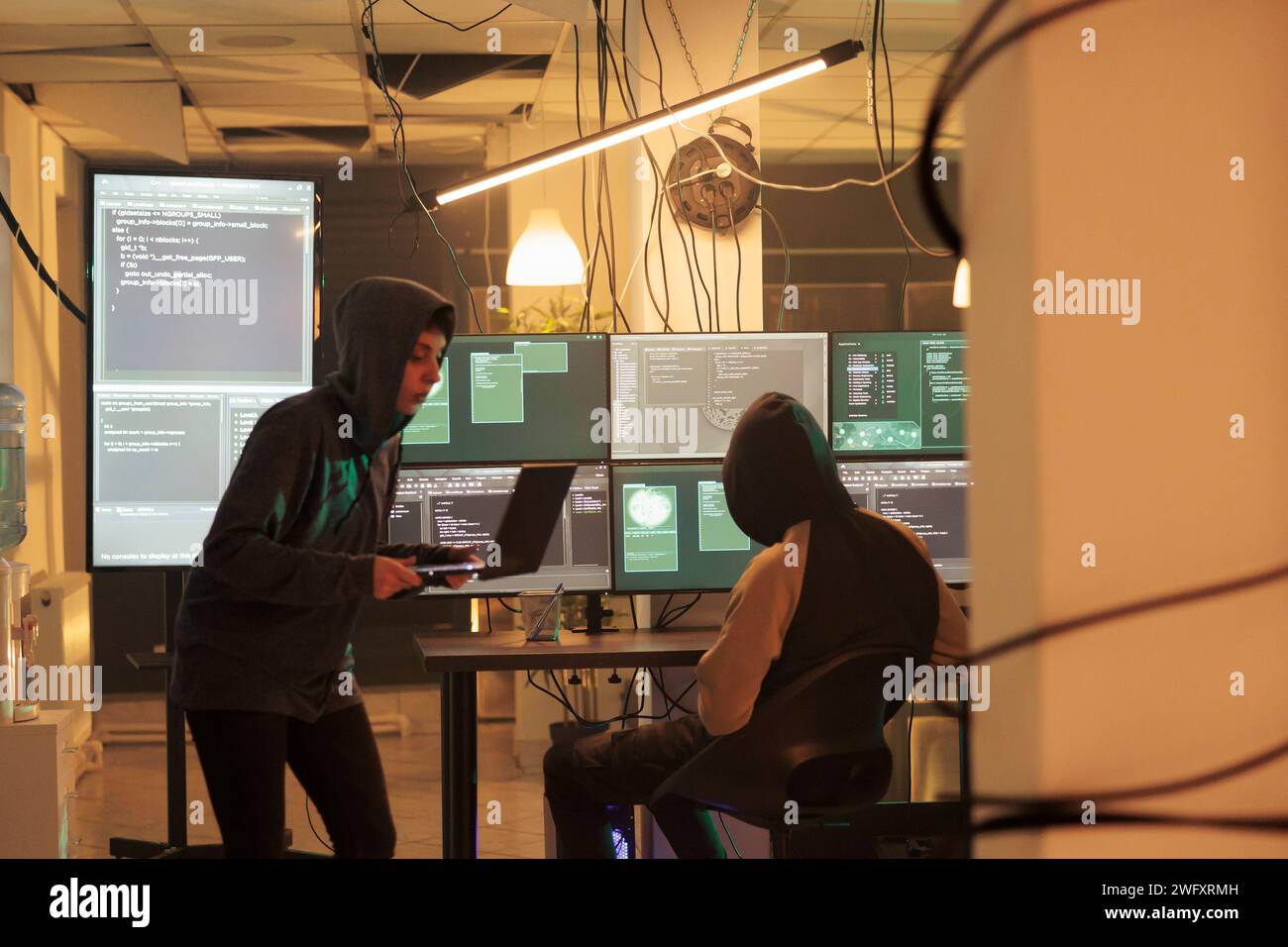 Hackers coding spyware, cracking database password, getting illegal access, data breach. Cybercrime, internet thieves hacking computer network system, developing malicious software Stock Photo