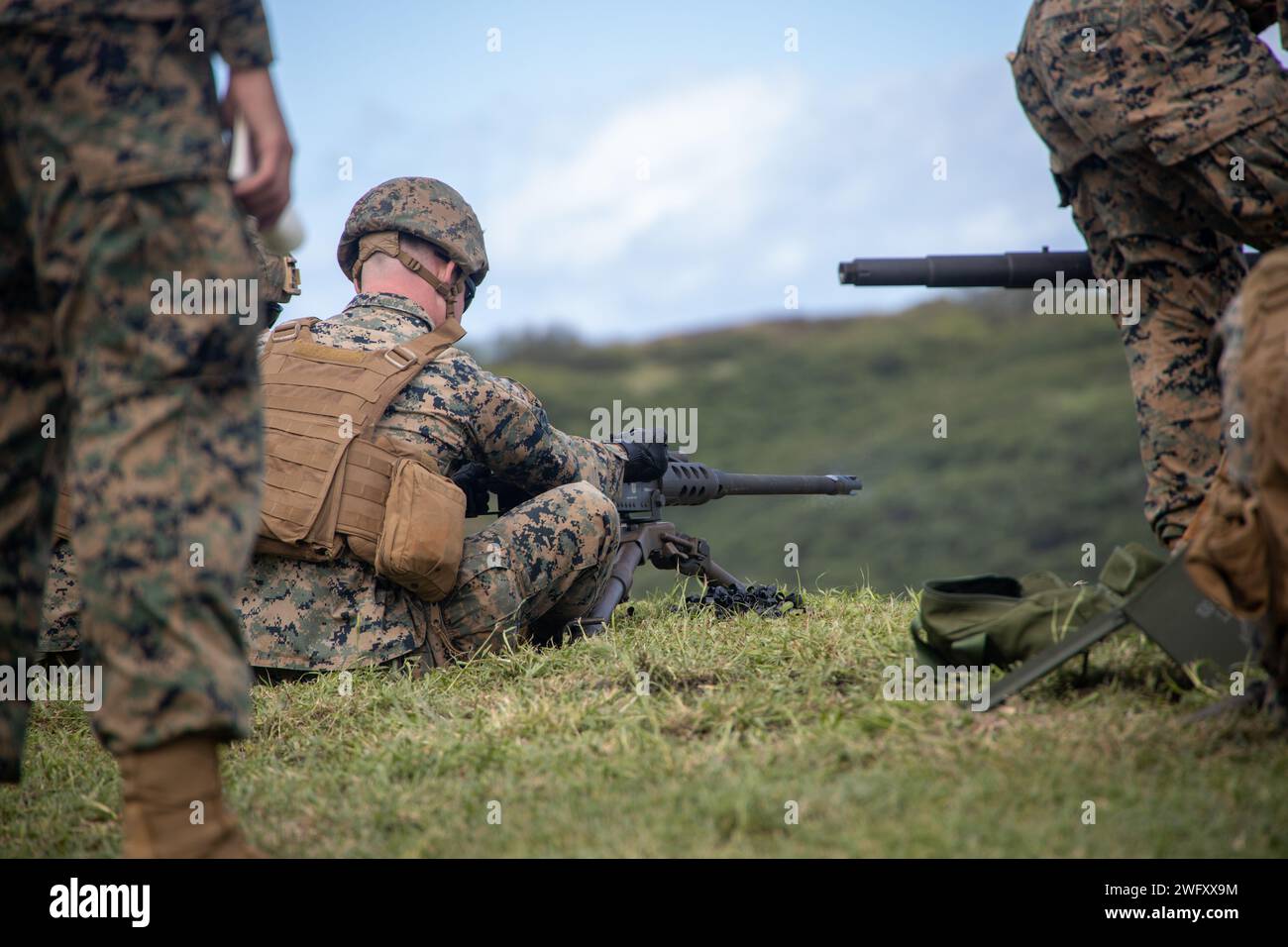 U.S. Marines with Marine Wing Support Squadron (MWSS) 174, Marine Aircraft Group 24, 1st Marine Aircraft Wing, fire M240-B and M2 .50-caliber machine guns at the Marine Corps Air Station Kaneohe Bay range, Hawaii, Jan. 16, 2024. The training provided an opportunity for Marines with MWSS-174 to get hands-on training and familiarization with the employment of crew-served weapons. Stock Photo