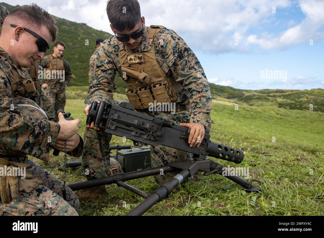 U.S. Marines with Marine Wing Support Squadron (MWSS) 174, Marine Aircraft Group 24, 1st Marine Aircraft Wing, prepare to fire M240-B and M2 .50-caliber machine guns at the Marine Corps Air Station Kaneohe Bay range, Hawaii, Jan. 16, 2024. The training provided an opportunity for Marines with MWSS-174 to get hands-on training and familiarization with the employment of crew-served weapons. Stock Photo