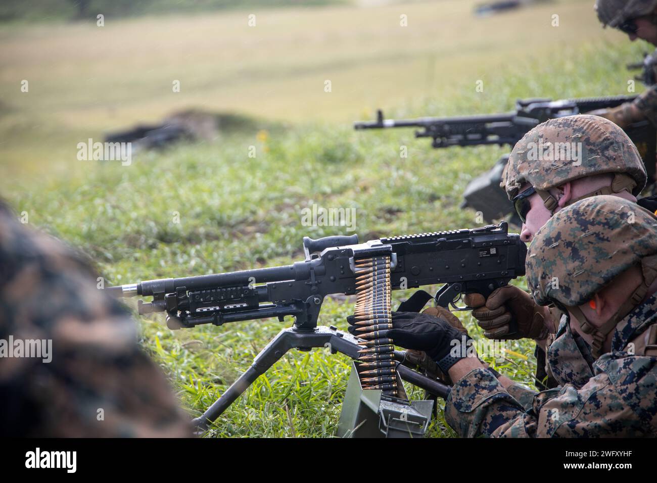 U.S. Marines with Marine Wing Support Squadron (MWSS) 174, Marine Aircraft Group 24, 1st Marine Aircraft Wing, fire M240-B and M2 .50-caliber machine guns at the Marine Corps Air Station Kaneohe Bay range, Hawaii, Jan. 16, 2024. The training provided an opportunity for Marines with MWSS-174 to get hands-on training and familiarization with the employment of crew-served weapons. Stock Photo