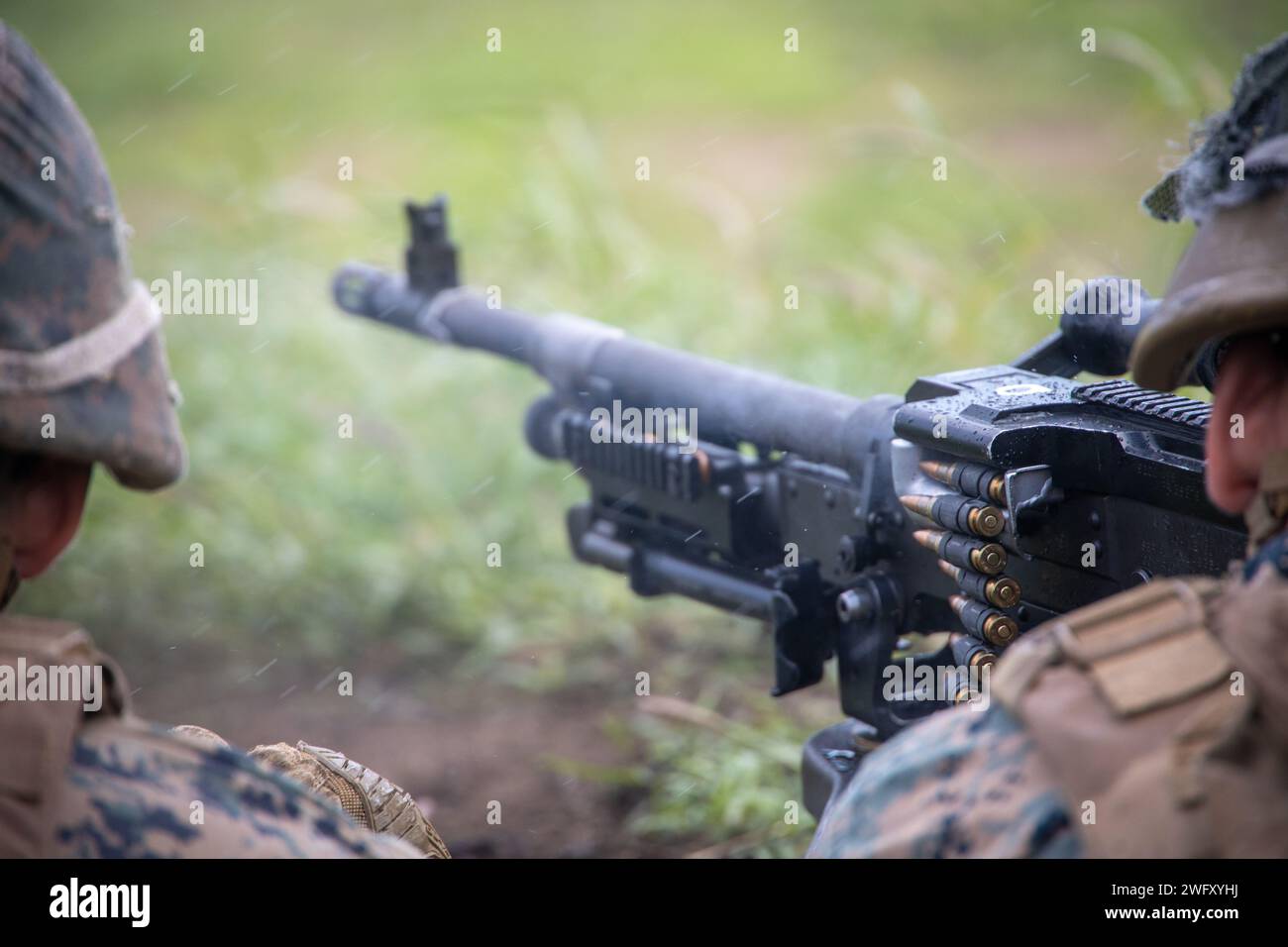 U.S. Marines with Marine Wing Support Squadron (MWSS) 174, Marine Aircraft Group 24, 1st Marine Aircraft Wing, fire M240-B and M2 .50-caliber machine guns at the Marine Corps Air Station Kaneohe Bay range, Hawaii, Jan. 16, 2024. The training provided an opportunity for Marines with MWSS-174 to get hands-on training and familiarization with the employment of crew-served weapons. Stock Photo