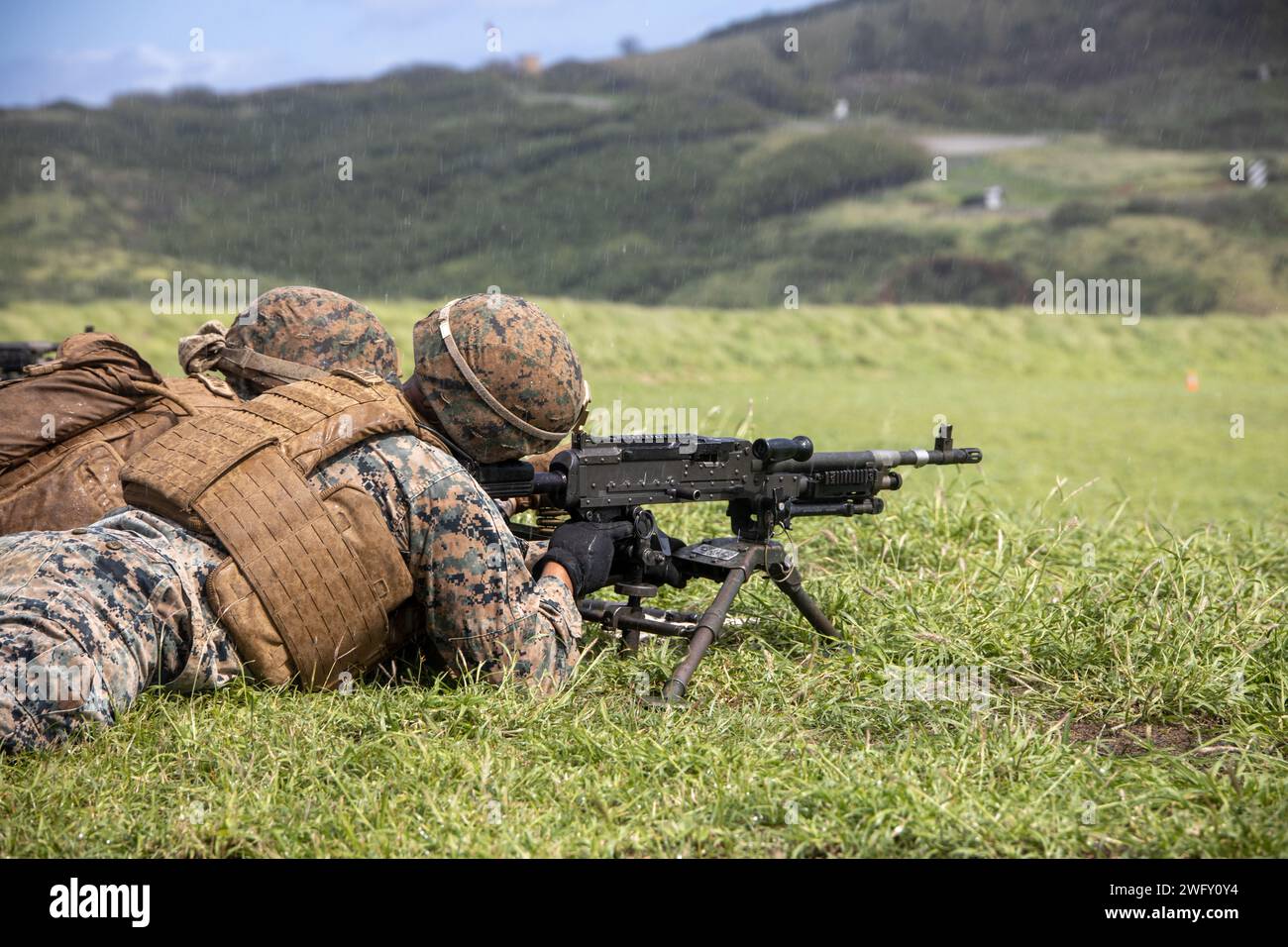 U.S. Marines with Marine Wing Support Squadron (MWSS) 174, Marine Aircraft Group 24, 1st Marine Aircraft Wing, prepare to fire M240-B and M2 .50-caliber machine guns at the Marine Corps Air Station Kaneohe Bay range, Hawaii, Jan. 16, 2024. The training provided an opportunity for Marines with MWSS-174 to get hands-on training and familiarization with the employment of crew-served weapons. Stock Photo
