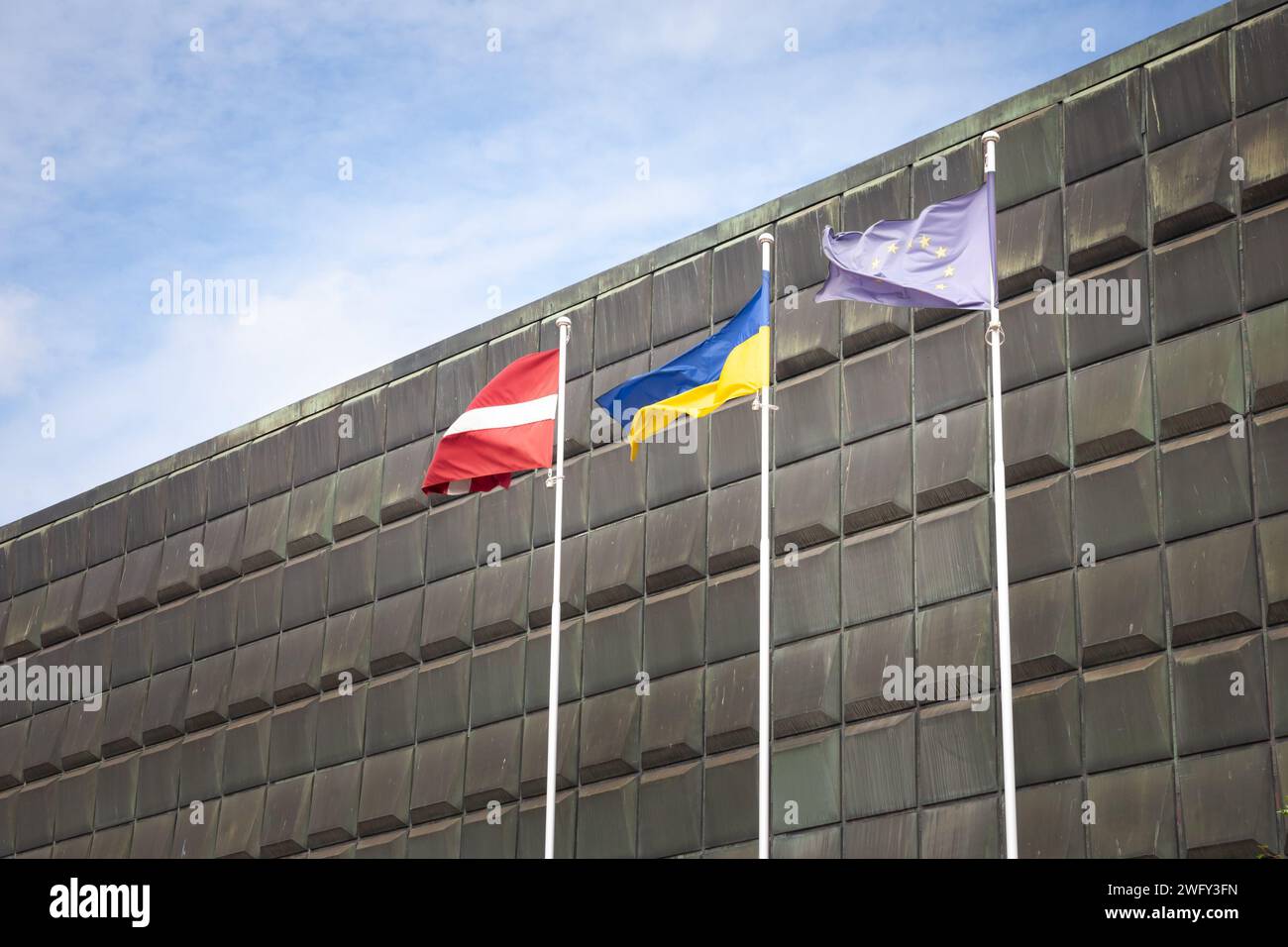 Picture of the ukrainian and Latvian flags waiving together in Riga, celebrating the solidarity between Latvia and Ukraine in the war against russia. Stock Photo