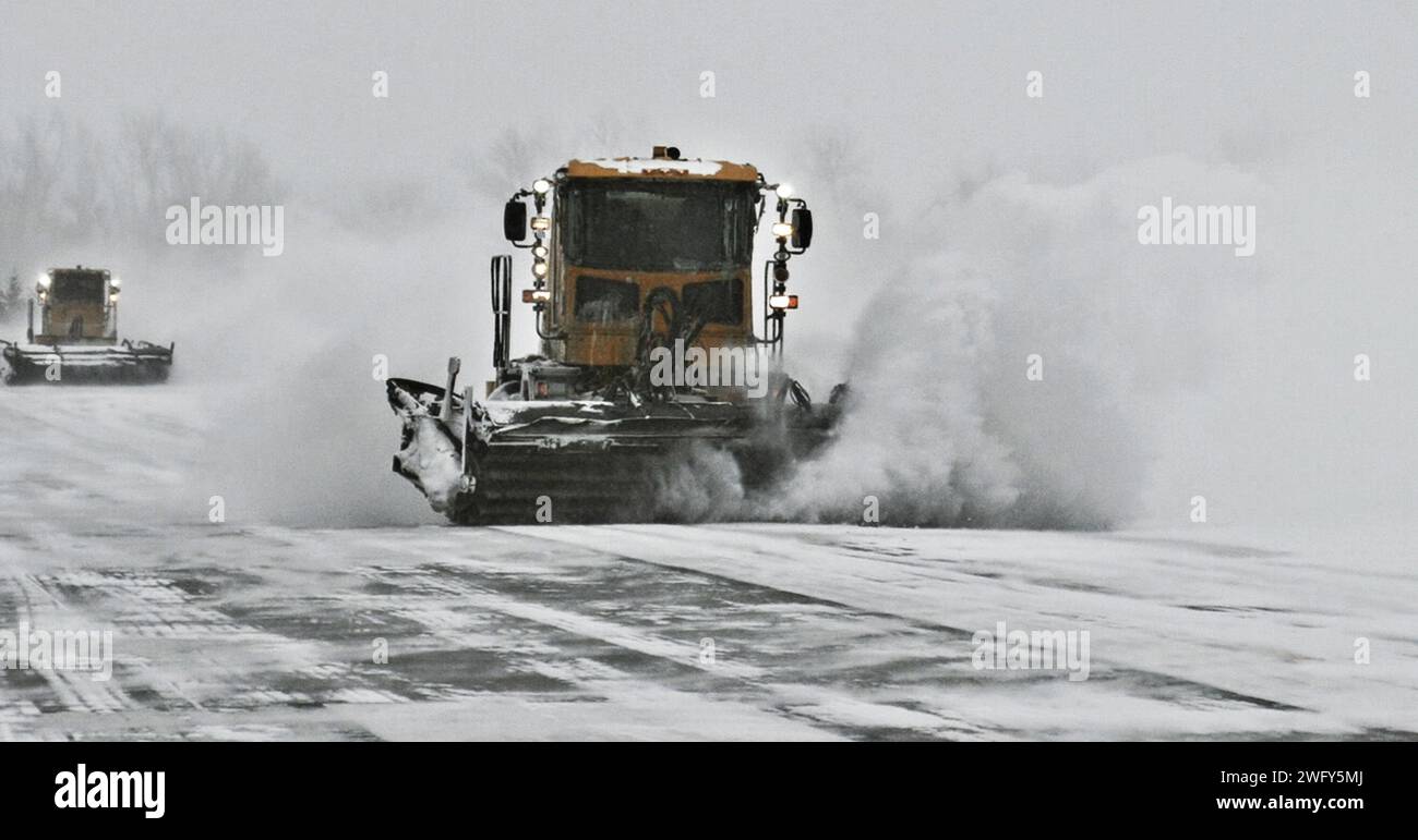 Snowplows from the 55th Civil Engineering Squadron clear the runway at Offutt Air Force Base Jan. 12, 2024. Removing the snow is the number one priority for reopening the base and continuing the mission. (U.S. Air Force photo by J.B. Artley) Stock Photo