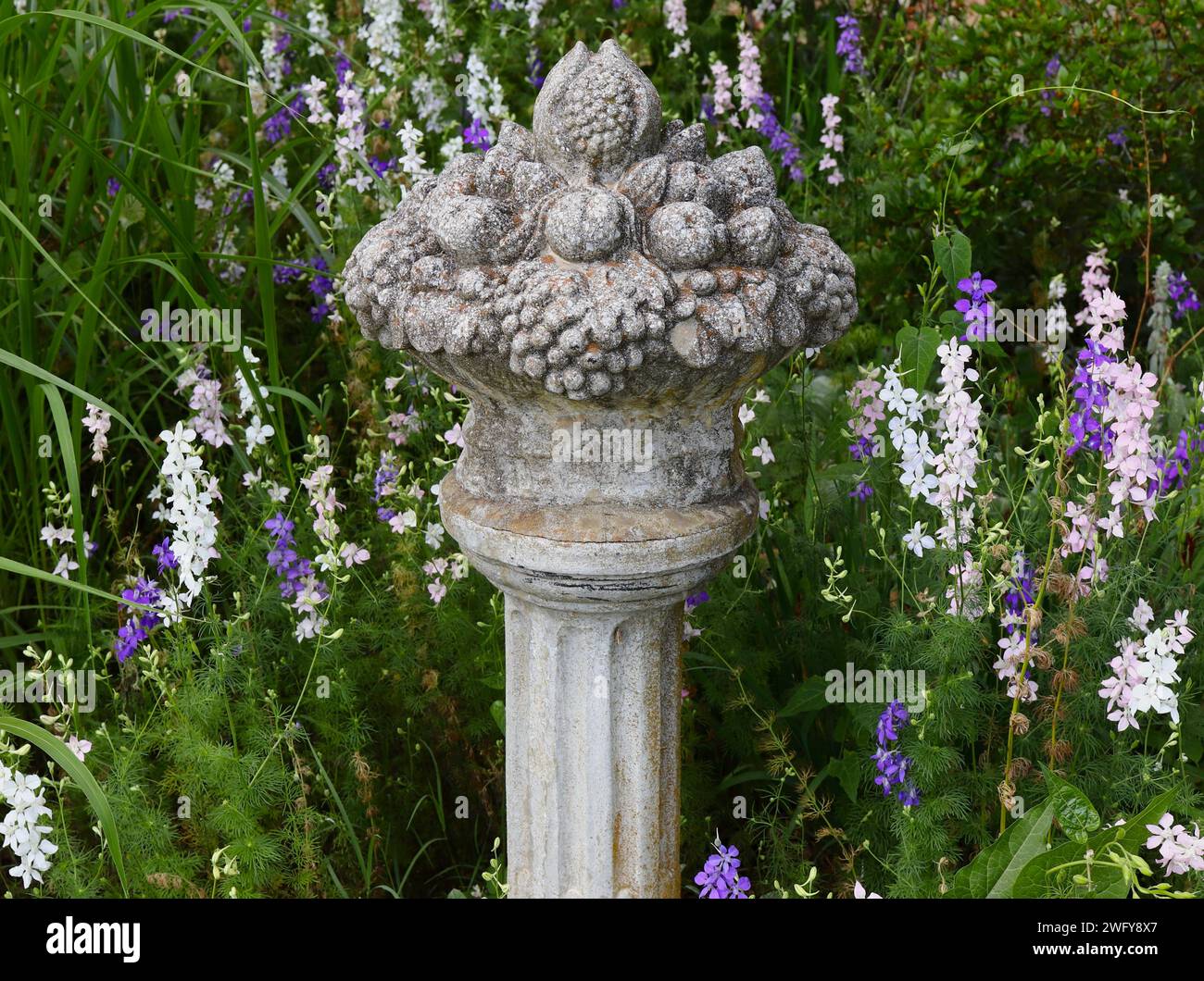 Replica of Ancient Roman Bowl of Fruit Sculpture on Pedestal Stock Photo