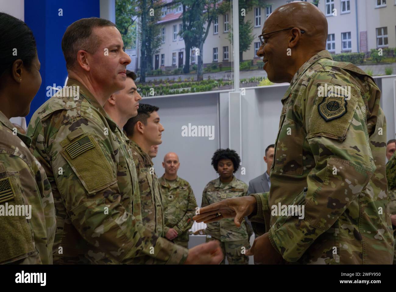 U.S. Army Capt. Randy Burdeaux, 773rd Military Police Battalion chaplain, receives a coin from Chairman of the Joint Chiefs of Staff Gen. CQ Brown, Jr. on Camp Kosciuszko, Poland, Jan. 20, 2024. Capt. Bordeaux has provided extensive counseling, support, and proactive solutions to nearly 500 soldiers across six countries, demonstrating his love for people and dedication to serving others. Stock Photo