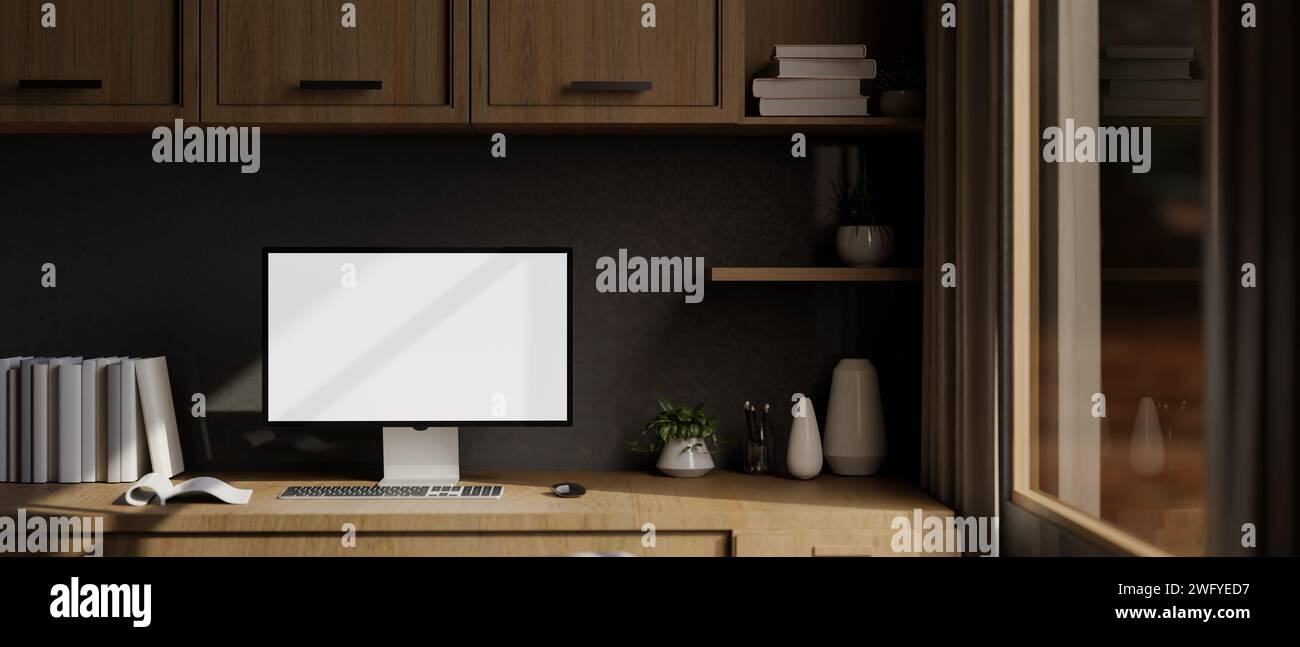 A modern home office workspace with a white-screen computer mockup on a wooden desk, a wooden wall cabinet, and decor. 3d render, 3d illustration Stock Photo