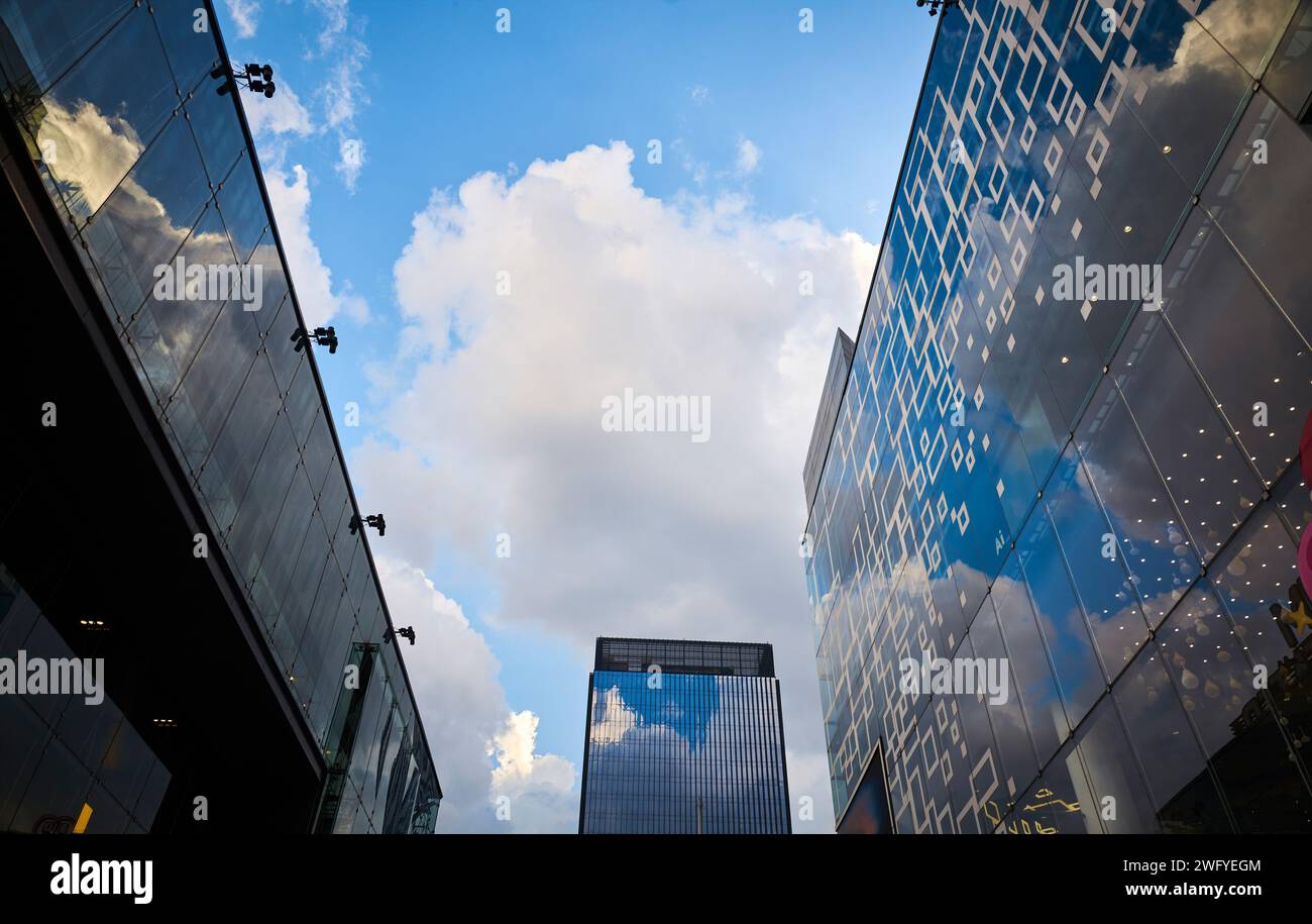 Modern glass exterior of business office building against sky from low angle view at Siam square in Bangkok, Thailand. Stock Photo