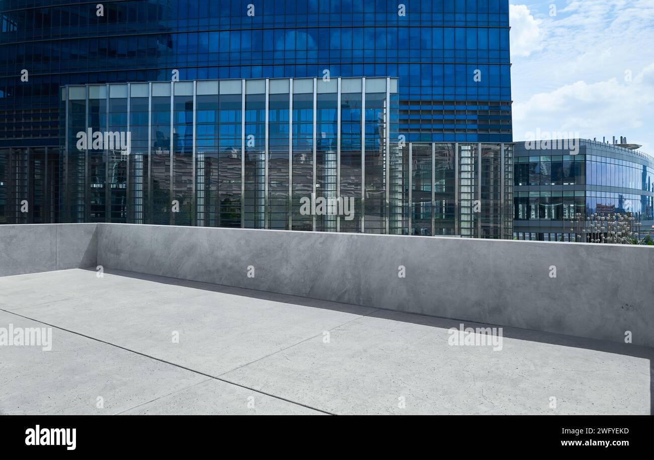 Empty cement balcony with steel and blue glass facade office building Stock Photo