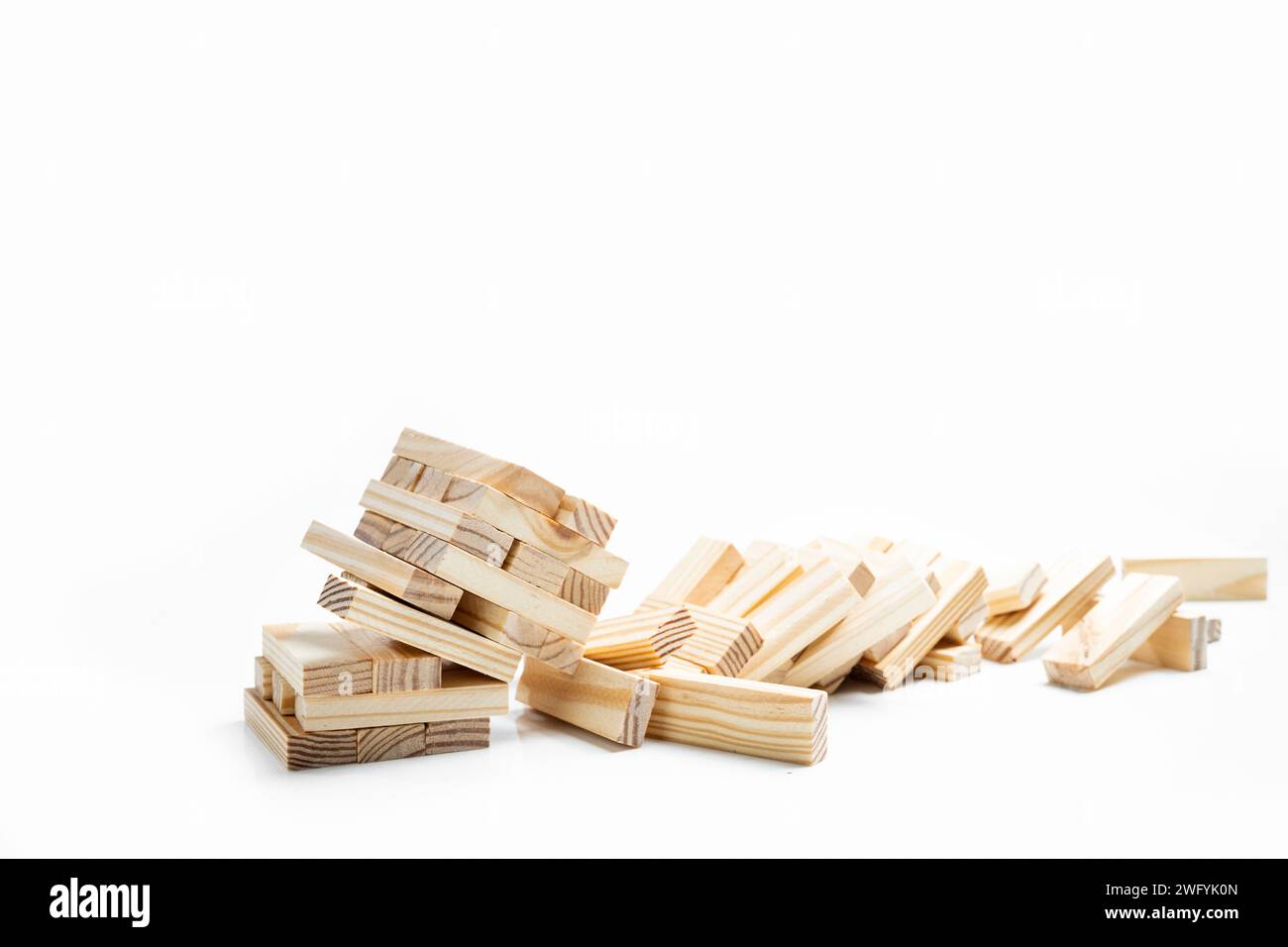 Closeup view of the tower of the wooden block falling on a white background. Jenga tower Stock Photo