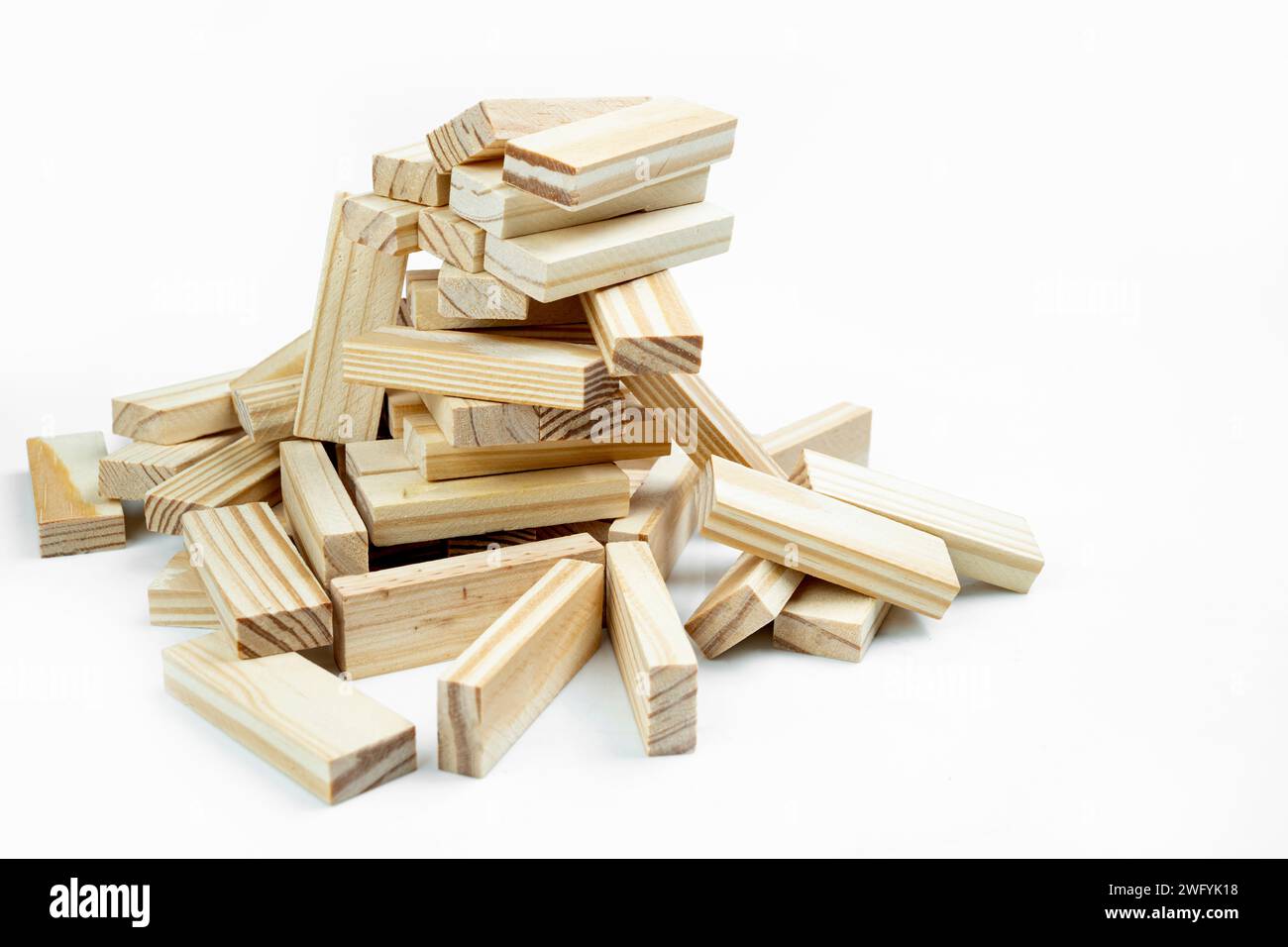 Closeup view of the tower of the wooden block falling on a white background. Jenga tower Stock Photo