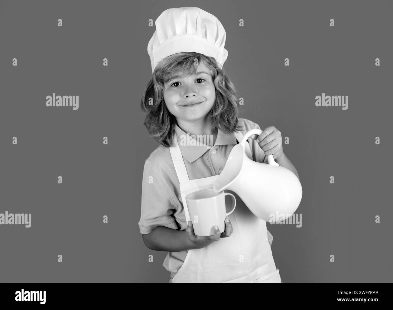 Milk for kids. Chef kid boy making fresh vegetables for healthy eat