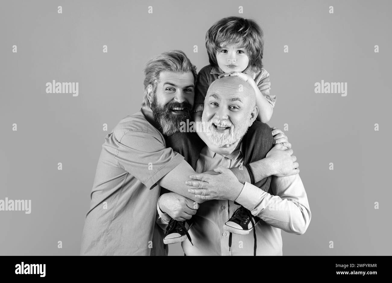 Grandfather father and son hugging and embracing isolated. Fathers day concept. Men in different ages cuddling bonding. Family tenderness hug, child l Stock Photo