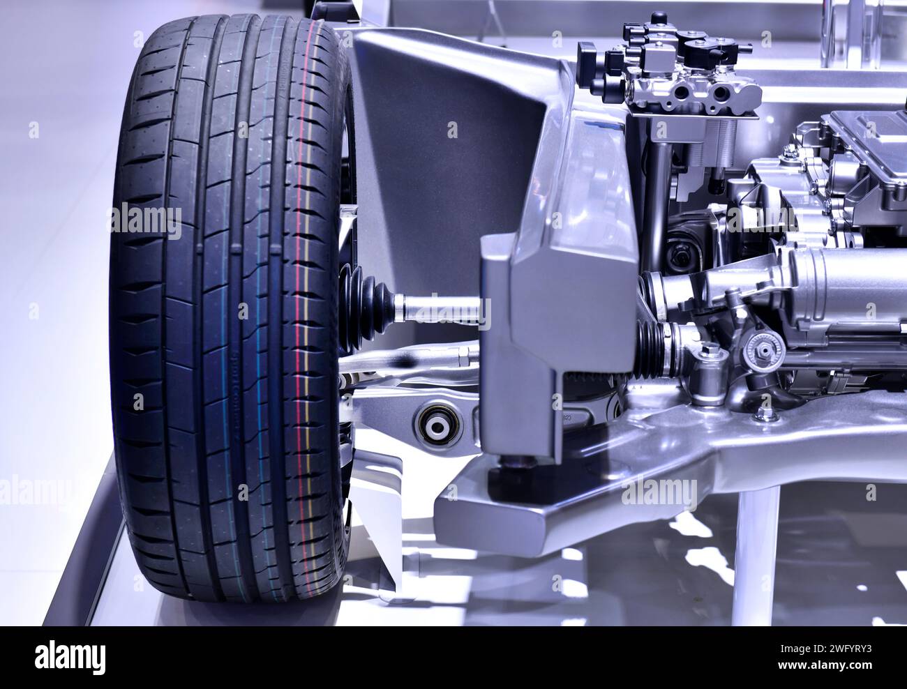 Electric Car Front Axle with new tire of the suspension structure an electric car. Stock Photo