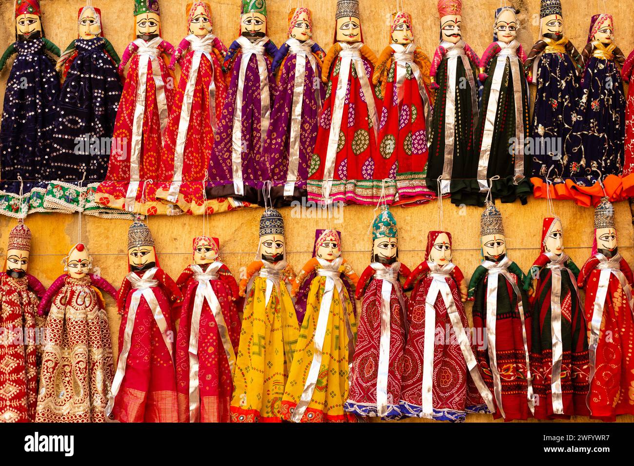 Colorful traditional handmade puppet dolls of India being sold at a