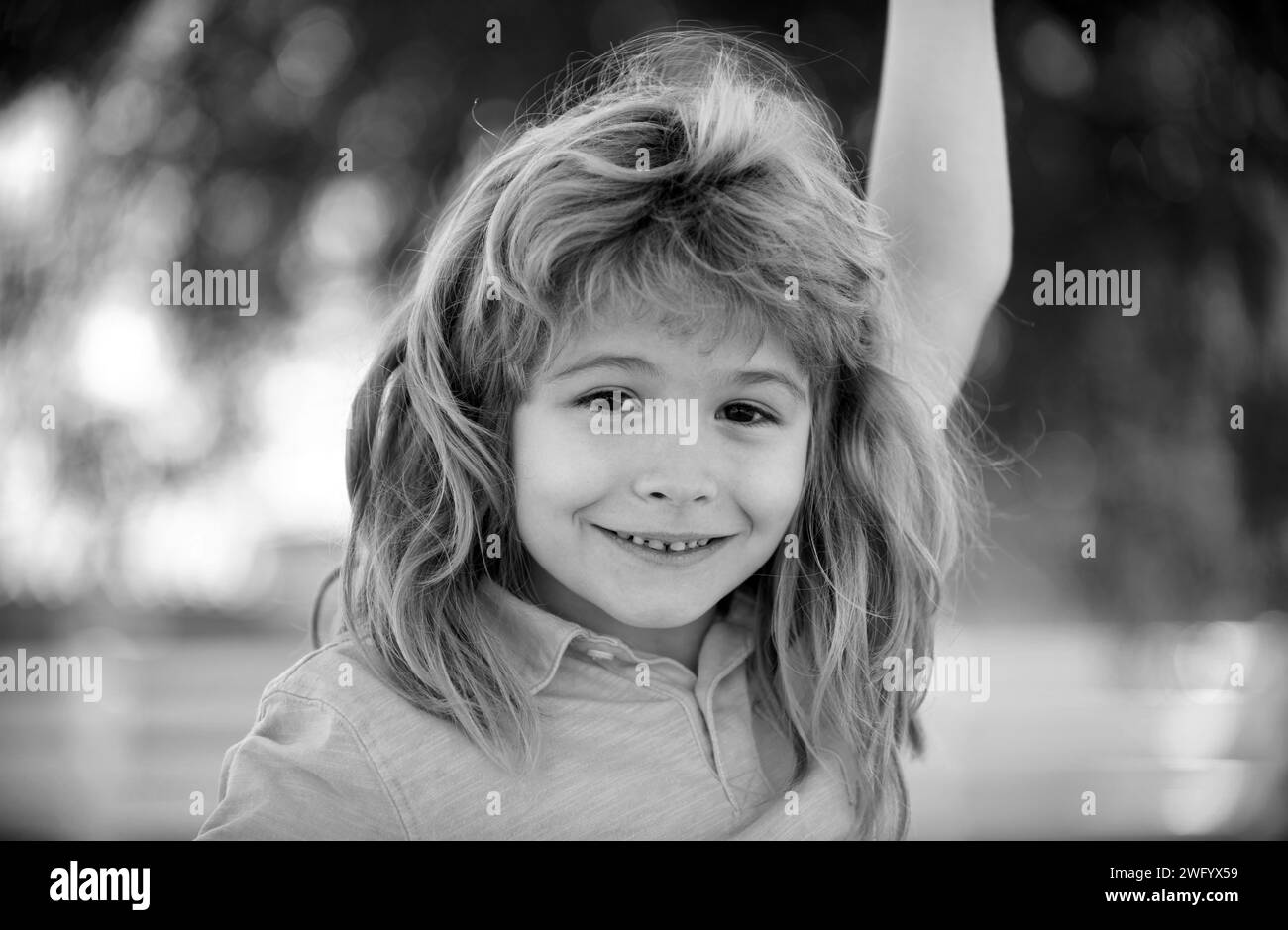 Portrait of smiling kid outdoor. Blonde child. Adorable little girl boy