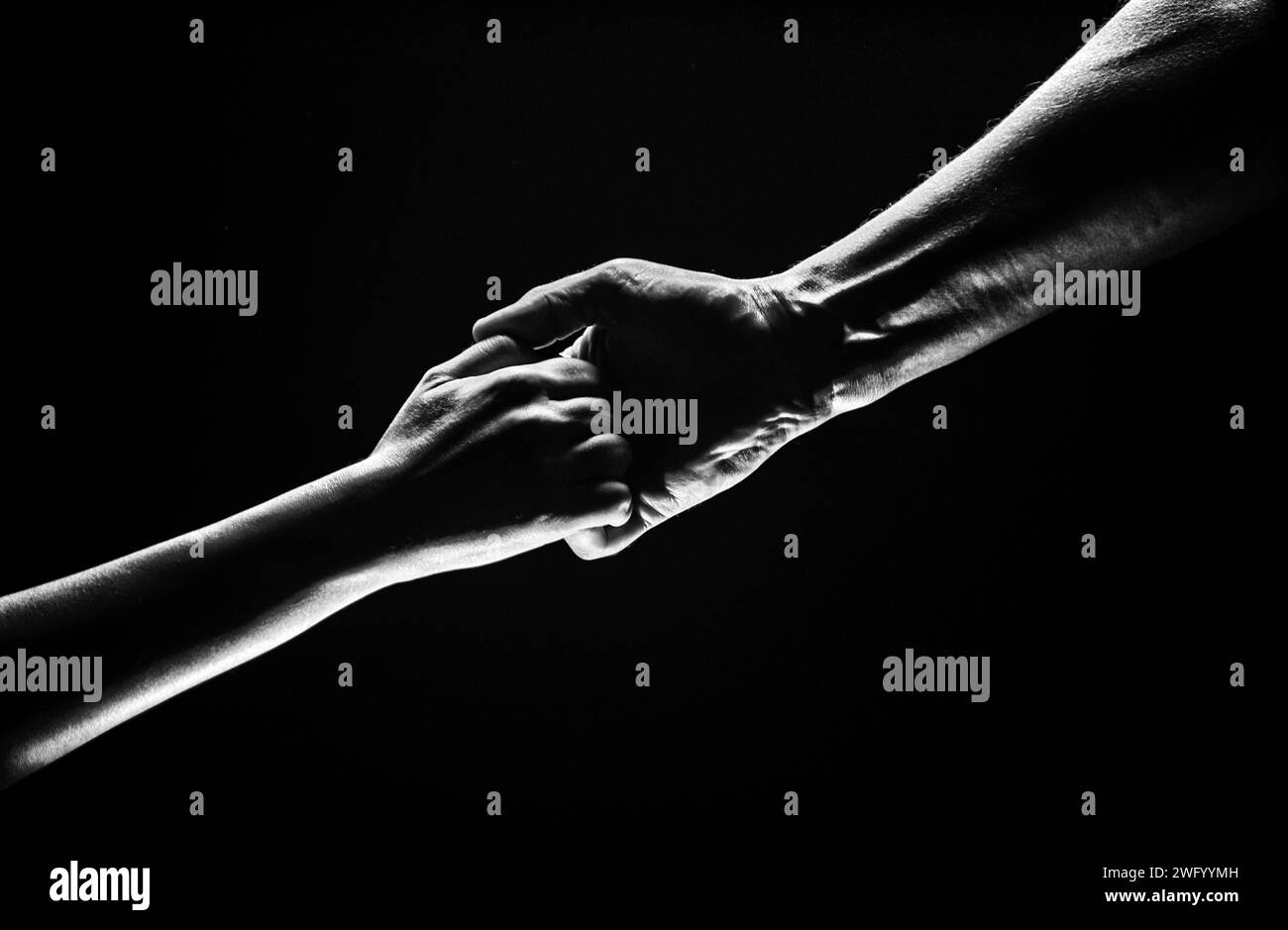 Helping hand outstretched, arm on salvation. Close up strong hand. Two hands, helping arm of a friend, teamwork. Rescue, power, helping gesture or han Stock Photo