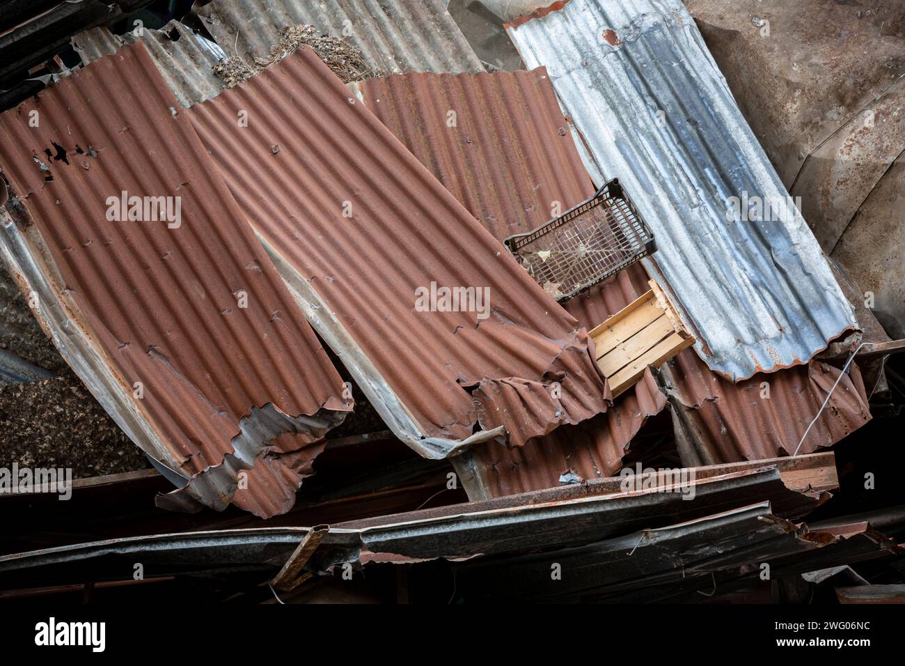 Closeup shot of a pile of battered corrugated iron sheets formed during