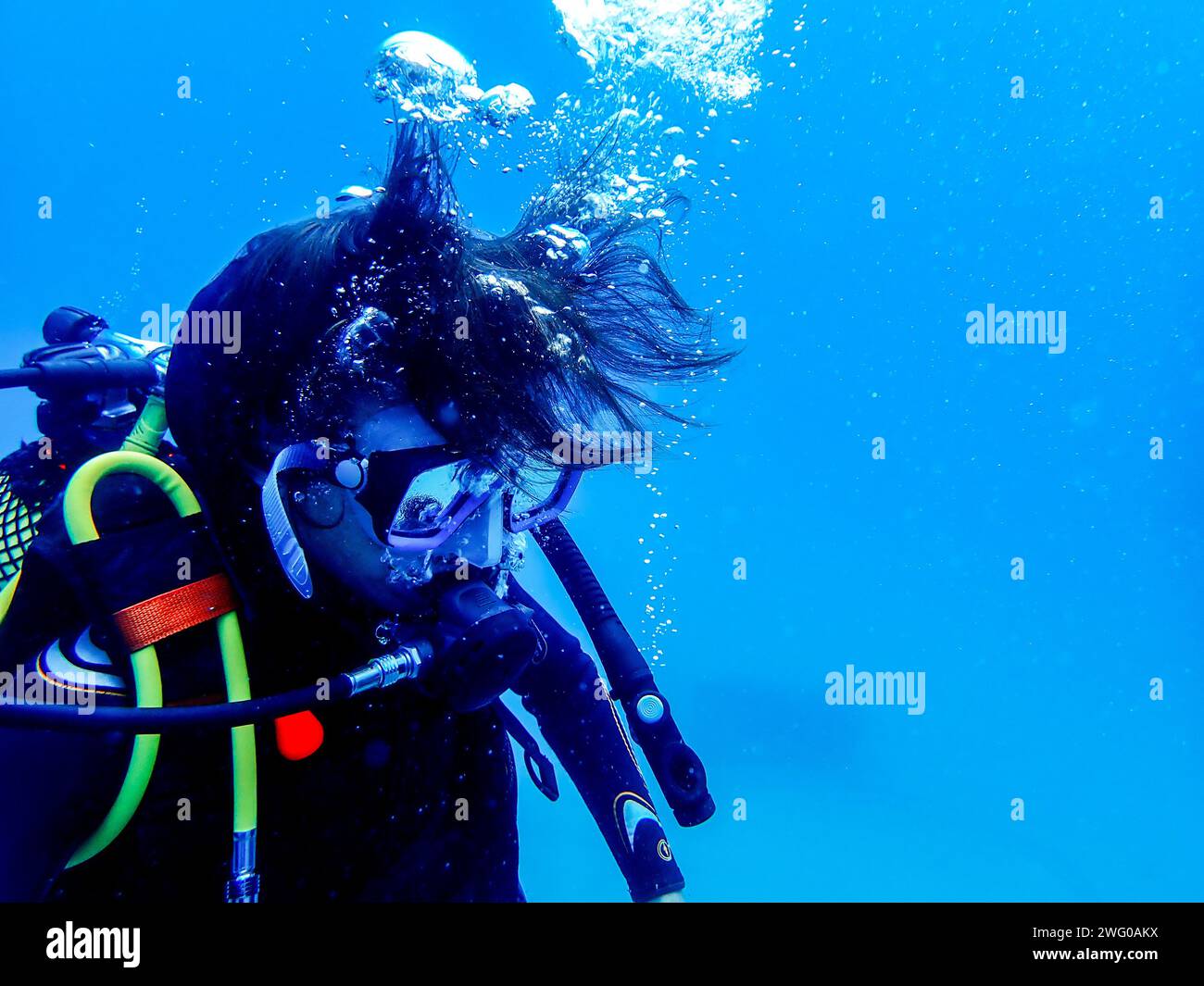 Diver in Lanzarote's deep blue, surrounded by bubbles, showcasing essential gear and the underwater allure Stock Photo