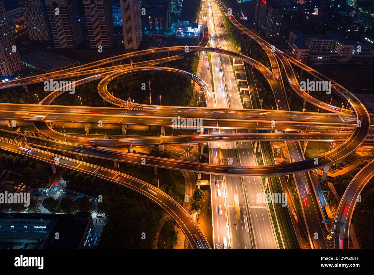 A bird's-eye view of the night view of Wuhan Guanggu Avenue overpass, with the wide urban main road illuminated by warm colored lights Stock Photo