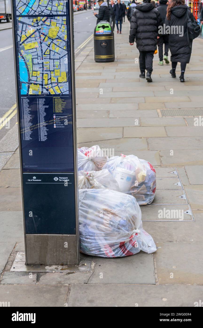 London, UK. Bags of rubbish left in The Strand Stock Photo