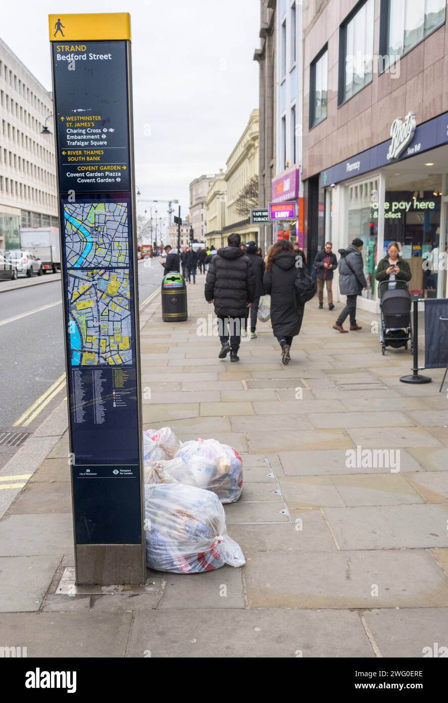 London, UK. Bags of rubbish left in The Strand Stock Photo