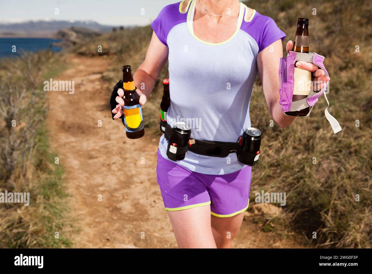 Mid Section Of An Athletic Women Runs With Session Beers For Hydration Stock Photo